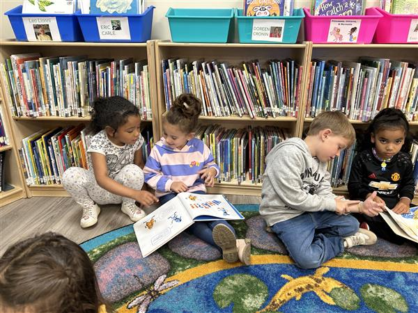 children  reading books in the library